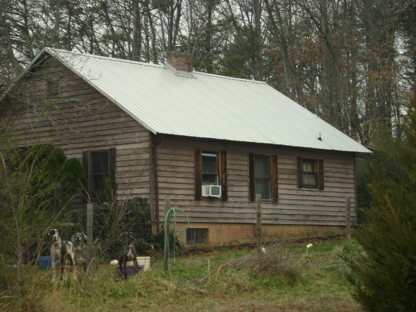 White metal roof on an old wood sided farmhouse, from a Asphalt Shingle Roof Repair job in Slatington